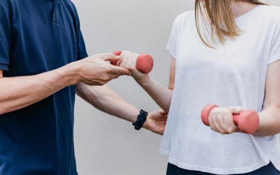 a man and a woman holding dumbs in their hands